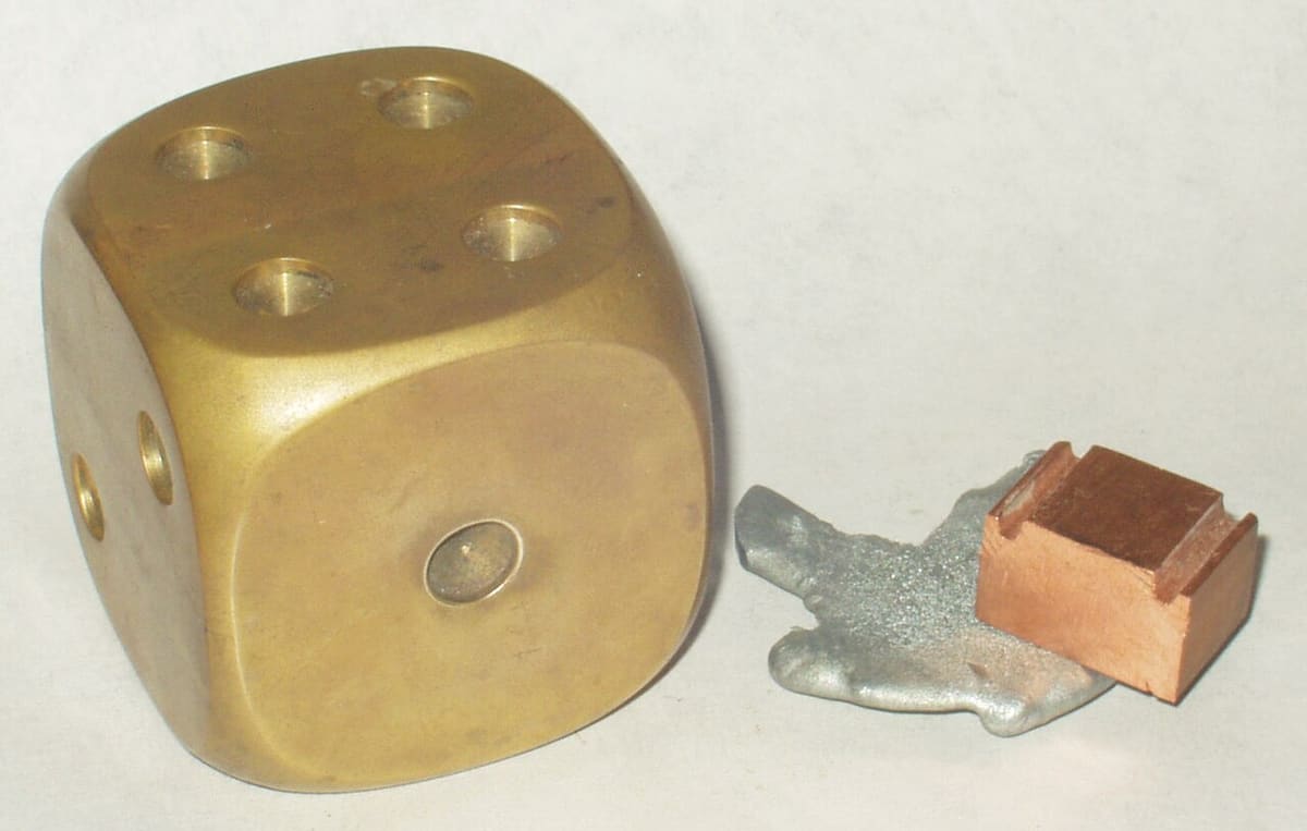 Brass scrap pieces: a solid brass block with small brass and zinc offcuts