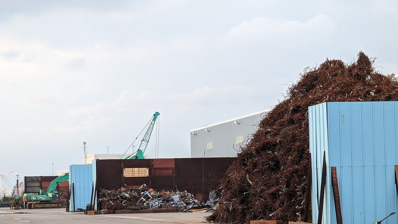 Large pile of shredded scrap metal at a port scrap yard